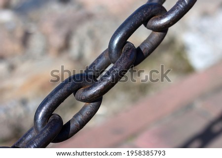 Heavy cast iron chain with rust. Protective fence on the bank of the Neva River in St. Petersburg.