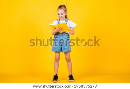 cute kid going to read information from book, back to school