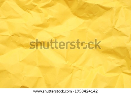 blank crumpled yellow paper for background Royalty-Free Stock Photo #1958424142