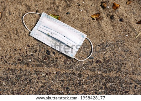 Clinical Mask lying in the sand