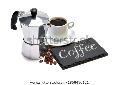 Coffee handwritten inscription sign on chalk board and cup of espresso on white background