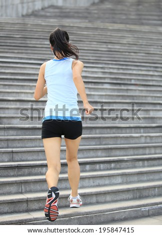 Runner athlete running on stairs. woman fitness jogging workout wellness concept. 
