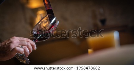 FRANCE, GIRONDE, SAINT-EMILION, SAMPLING A GLASS OF WINE IN A BARREL WITH A PIPETTE FOR TASTING AND VINIFICATION MONITORING Royalty-Free Stock Photo #1958478682
