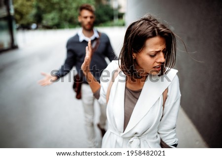 Sad young woman and man outdoor on street having relationship problems Royalty-Free Stock Photo #1958482021