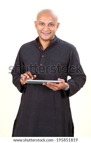 Handsome smiling bald or shaved head man holding tab,  isolated on white background.