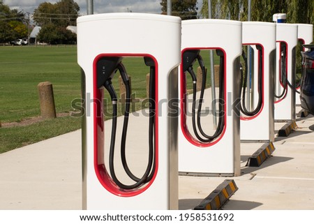 Electric car vehicle charger station. Environment friendly innovative feature. Royalty-Free Stock Photo #1958531692