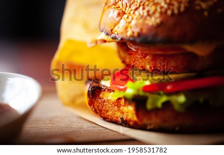Delicious hamburger served for dinner in American diner cafe.Download royalty free curated images collection with foods for design template