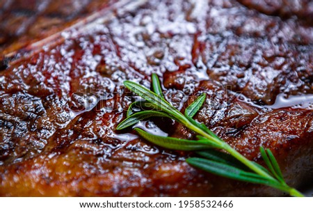T-bone steak cooked on grill in meat restaurant.Delicious beefsteak prepared for dinner.Download royalty free curated images collection with gourmet foods for design template