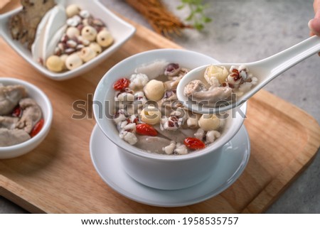 Four Tonics Soup. Close up of delicious homemade Taiwanese traditional Chinese herb flavor food with herbs, pork intestine on gray table background