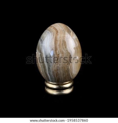 Easter egg with marble texture. Easter egg with marble stains. stone egg on a stand. ebru egg