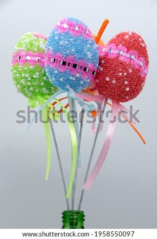 On the eve of Easter, a festive decoration in the form of colorful decorative Easter eggs on sticks.