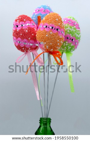 On the eve of Easter, a festive decoration in the form of colorful decorative Easter eggs on sticks.