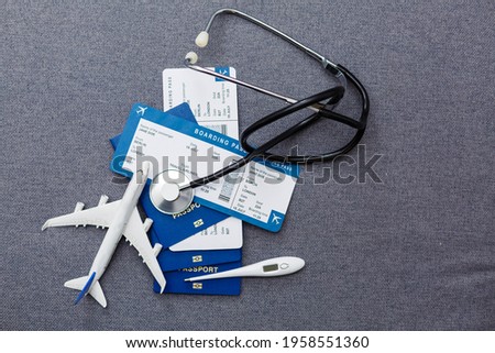 Coronavirus and travel concept. The concept of restrictions for tourism. Passport, thermomether and protective medical masks. Covid19 Corona virus disease danger pandemic spread worldwide global Royalty-Free Stock Photo #1958551360