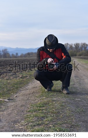 man photographs nature with dslr camera