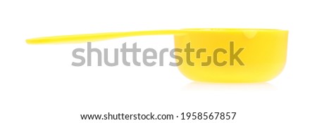 yellow plastic scoop isolated on white background