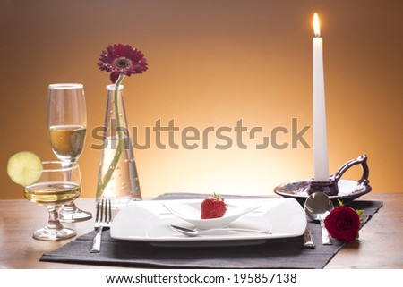 romantic set table with candlelight on brown background