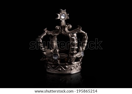 a closeup of a crown with black background Royalty-Free Stock Photo #195865214