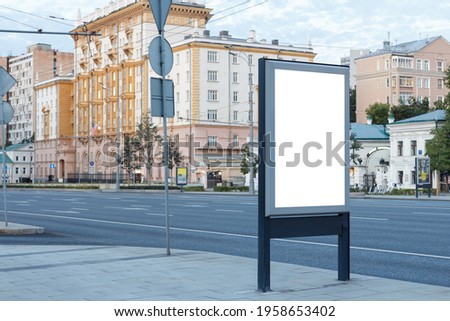 Vertical blank billboard in the historical part of the city on the sidewalk, mock up.