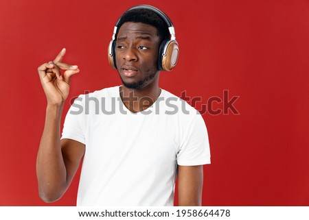 man in headphones listening to music in white t-shirt isolated background