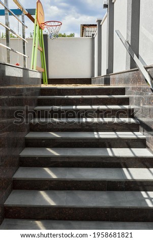 Modern stone staircase made of granit in dark gray and light gray granite steles.