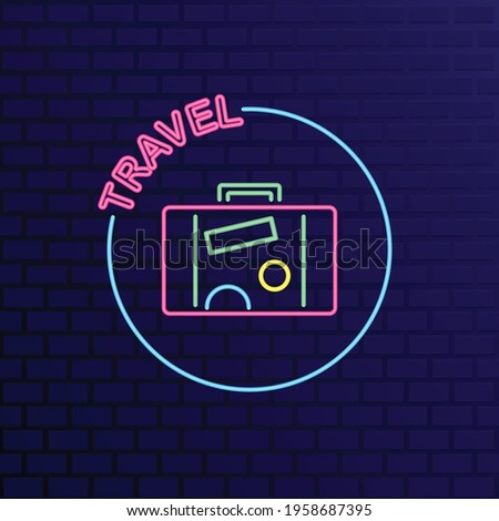 Travelling suitcase neon sign on dark blue  brick wall