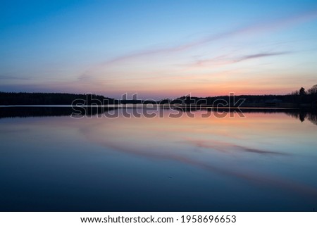 Lake and forest at sunset in Katrineholm Sweden. Beautiful scandinavian nature and landscape. Calm, peaceful photo.