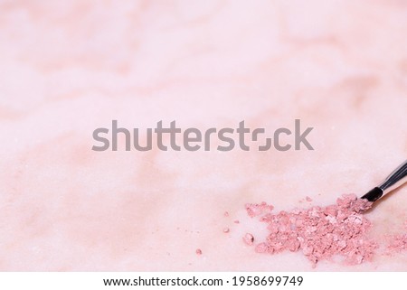 Pastel colored make-up on pink marble background