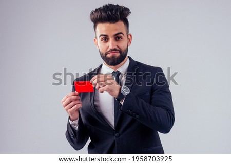 indian young handsome black hair man in stylish business suit holding credit card in studio isolate white background.contactless payment concept
