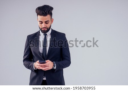 young handsome black hair man in stylish business suit in studio isolate white background