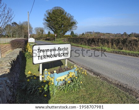 Roadside sign for Termonfeckin village or Tearmann Feichin in the Irish language, in County Louth, Ireland.  Royalty-Free Stock Photo #1958707981
