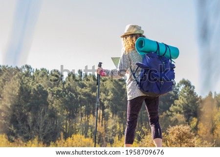 woman with backpack and map hiking