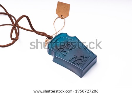 Amulet in the form of a tombstone. On white background.