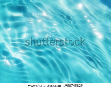 Closeup​ abstract​ of​ surface​ blue​ water. Abstract​ of​ surface​ blue​ water​ reflected​ with​ sunlight​ for​ background. Blue​ sea. Blue​ water.​ Water​ splashed​ use​ for​ graphic​ design.