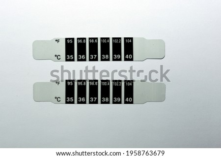 Fast Check Forehead Thermometer Strip. for Home or School. Reusable Color Change Bands Monitor Fever and Temperature of Infants, Babies, Toddlers and Kids. Quick Read in Celsius and Fahrenheit Scales Royalty-Free Stock Photo #1958763679