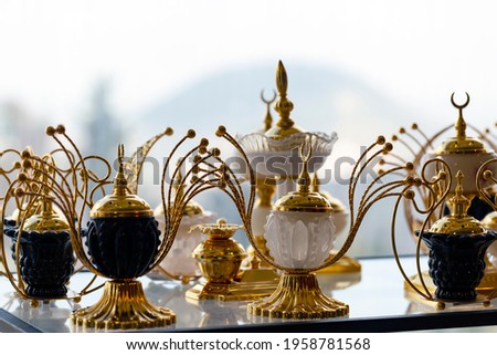 Table lamp with golden decoration. Mosques dome and crescent moon, symbol islamic religion and free space background well for text arabic present. Blurred background, selective focus