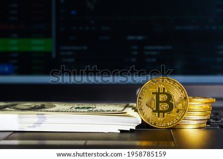 Bitcoins coin and banknotes on keyboard computer. Close up of  bitcoin crypto currency coins