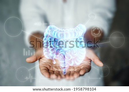 Doctor and holographic bowel scan projection with vital signs and medical records. Concept of new technologies, body scan, digital x-ray, abdominal organs, modern medicine Royalty-Free Stock Photo #1958798104