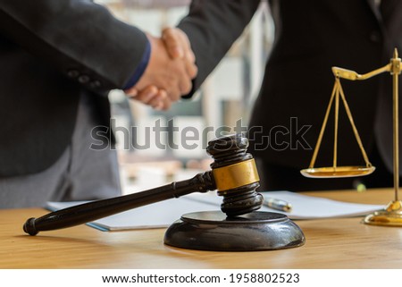 Good service, male business man consultation, shaking hands, male lawyer or judge adviser.Have a team meeting with clients, legal ideas in the office.