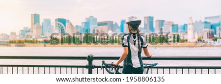 Biking outdoor cyclist on bike path at Old Port of Montreal view cityscape panoramic banner. Woman on bicycle wearing helmet. Summer sports city lifestyle.