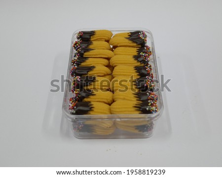 some Eid cakes or nastar in a jar on an isolated white background