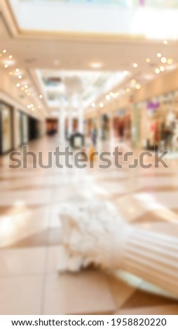 Abstract blur modern shopping center. Mall high fashion on light defocus background. Vertical photo.