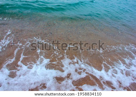 clear sea waves and sandy beach