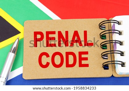 Law and justice concept. Against the background of the flag of South Africa lies a notebook with the inscription - PENAL CODE