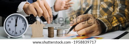 businessman holding coins putting in glass and using calculator. concept saving money and finance accounting.