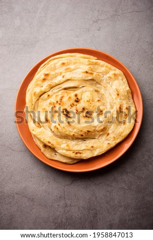Laccha Paratha is a layered Puffed Flatbread with lots of ghee or oil Royalty-Free Stock Photo #1958847013
