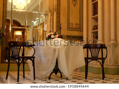 A beautiful romantic room with elegant Italian furniture, a luxurious chandelier and fresh flowers.