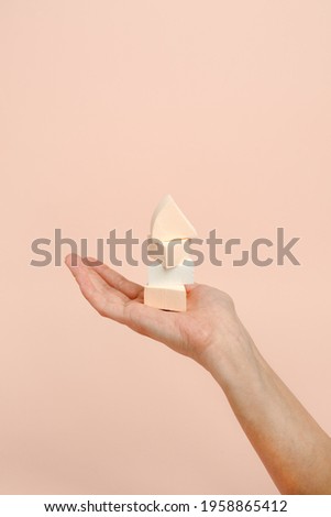 Cosmetic sponge beauty blender in woman hand on a beige background, modern trendy still life, monochrome, earth tones, neutral, beauty industry, makeup artist, face care, copy space, banner