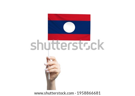 Beautiful female hand holding Laos flag, isolated on white background.