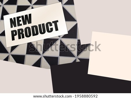 New Product words on card on wooden table. Business concept.