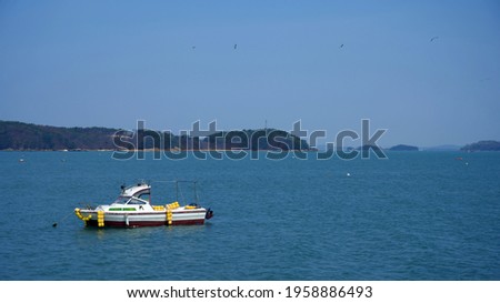 A fishing boat anchored in a calm sea.